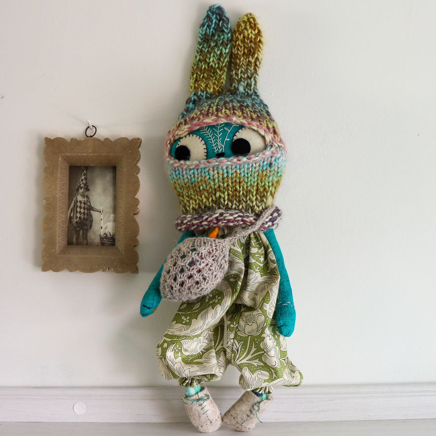 cloth doll kitty in a knitted bunny balaclava