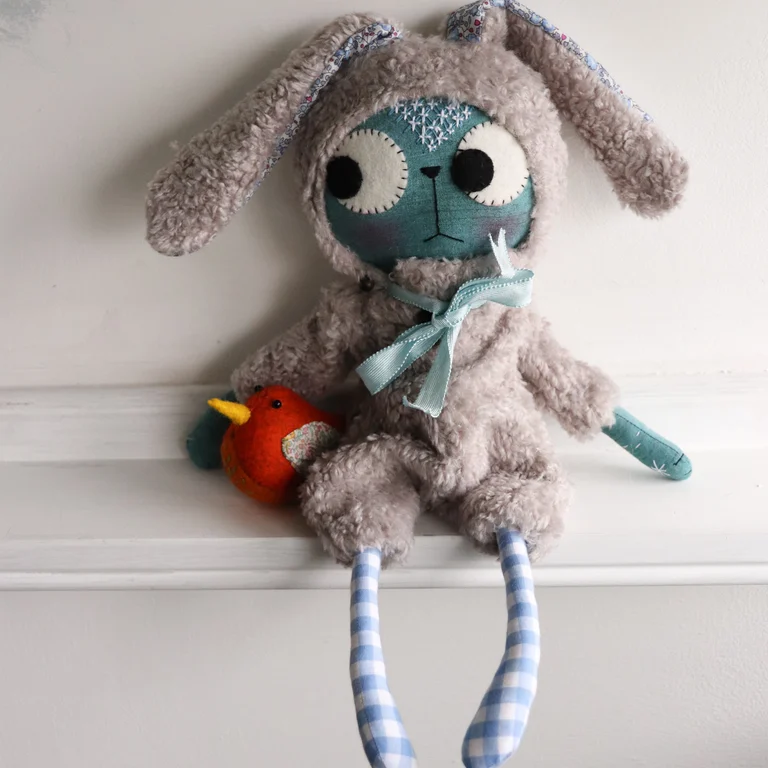 buny cat doll with a carrot coloured bird doll