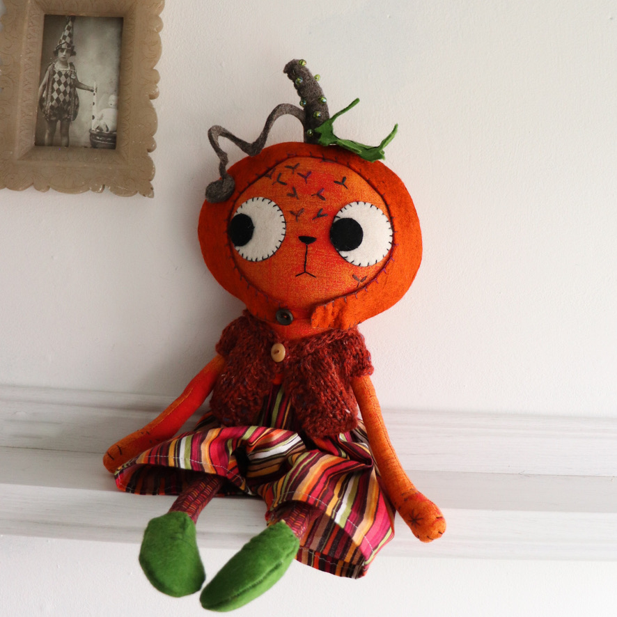 cat doll in a pumpkin hat