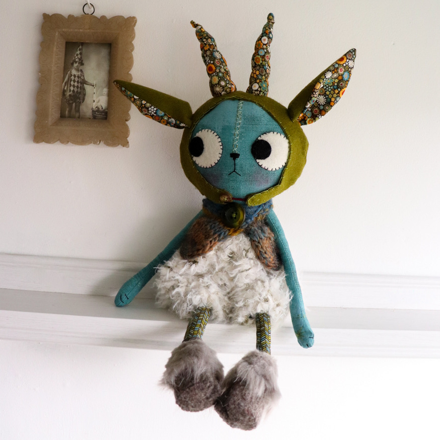 Cat doll in goat costume