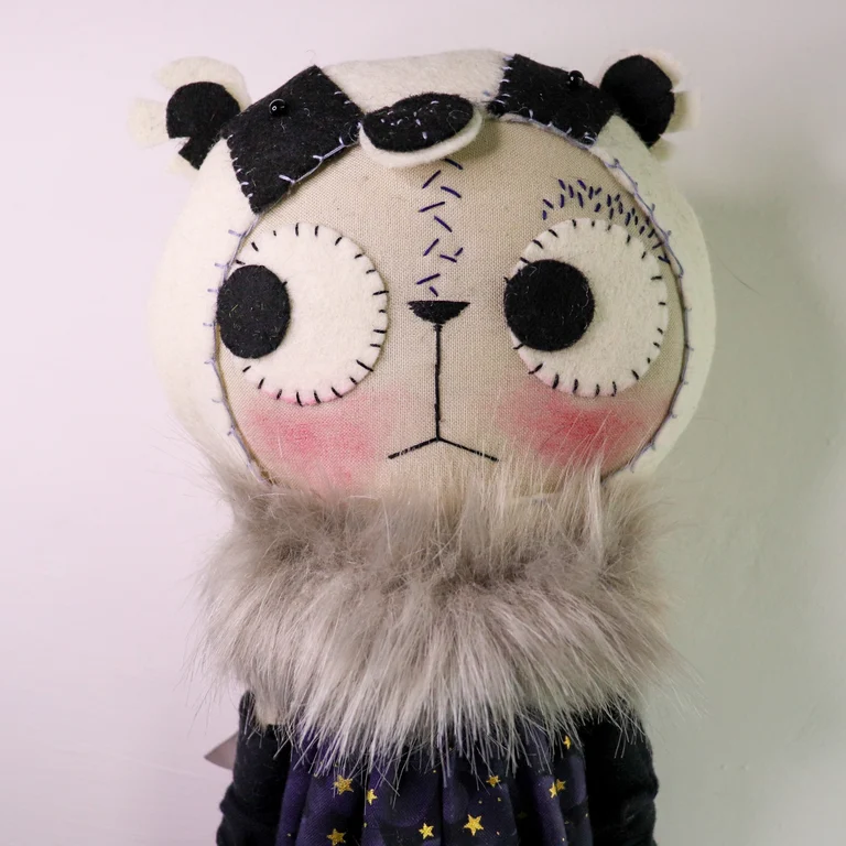 coth cat doll in a badger sostume