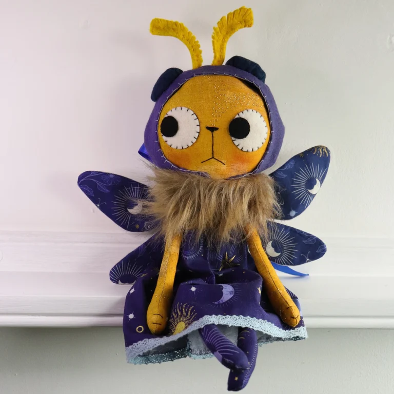 cat doll in a moth costume